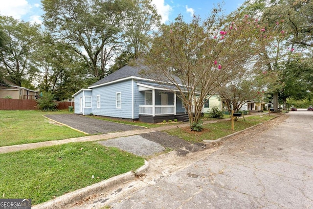 bungalow-style house with a porch and a front yard