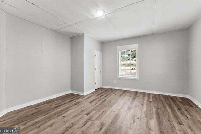 unfurnished room with hardwood / wood-style floors