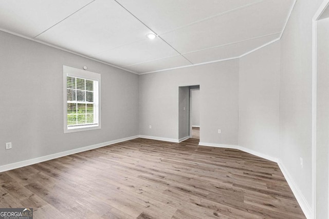 unfurnished room featuring hardwood / wood-style flooring and ornamental molding