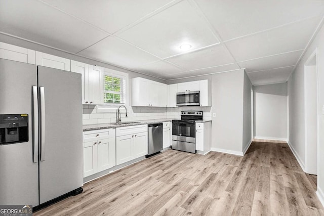 kitchen featuring sink, appliances with stainless steel finishes, light wood-type flooring, and white cabinets