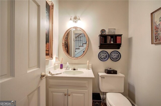 bathroom featuring toilet and vanity