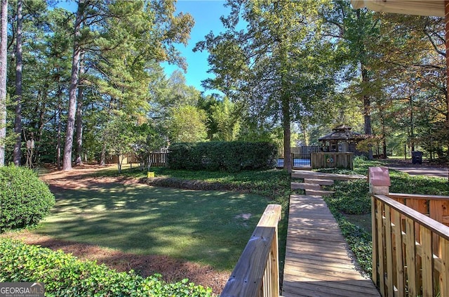 exterior space featuring a wooden deck and a lawn