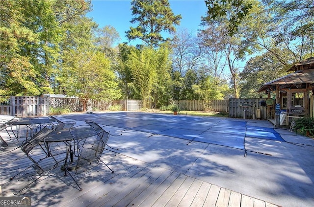 view of pool with a wooden deck and a gazebo