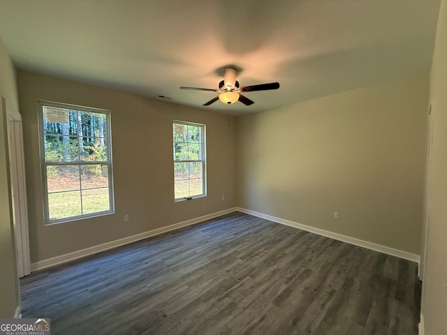 empty room featuring ceiling fan and dark hardwood / wood-style flooring