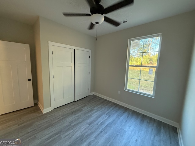 unfurnished bedroom featuring a closet, light wood-type flooring, and ceiling fan