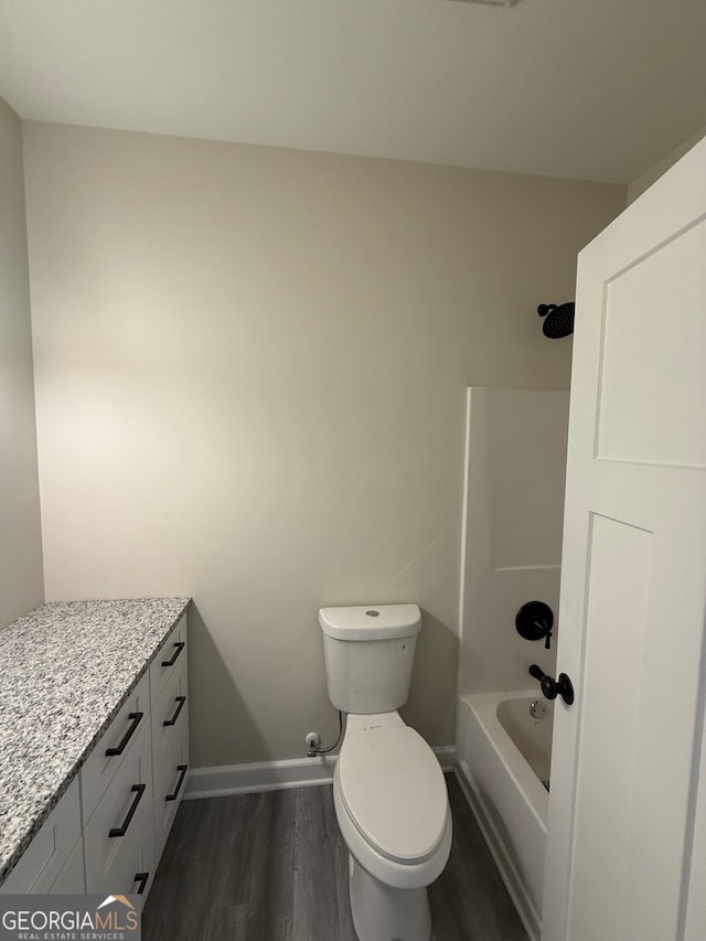 full bathroom with toilet, shower / tub combination, hardwood / wood-style flooring, and vanity