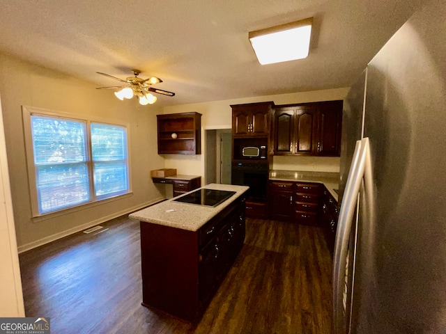 kitchen featuring dark brown cabinetry, black appliances, dark wood-type flooring, and a kitchen island