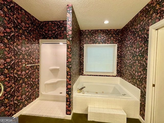 bathroom with tile patterned floors, shower with separate bathtub, and a textured ceiling