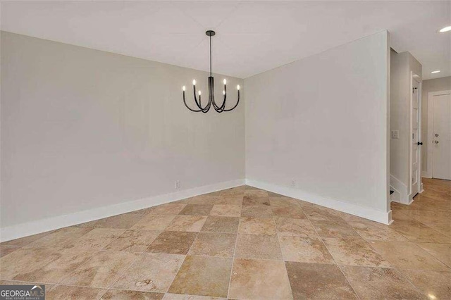 unfurnished dining area with a notable chandelier