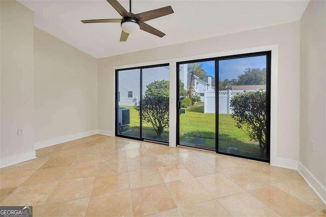 empty room featuring light tile patterned floors and ceiling fan