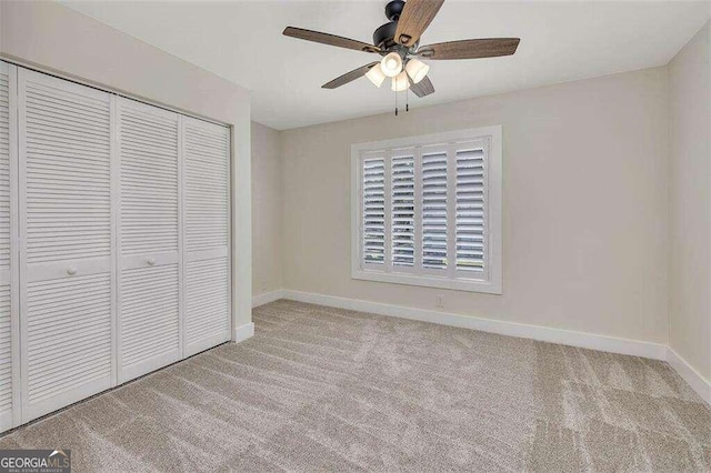 unfurnished bedroom featuring a closet, ceiling fan, and light colored carpet