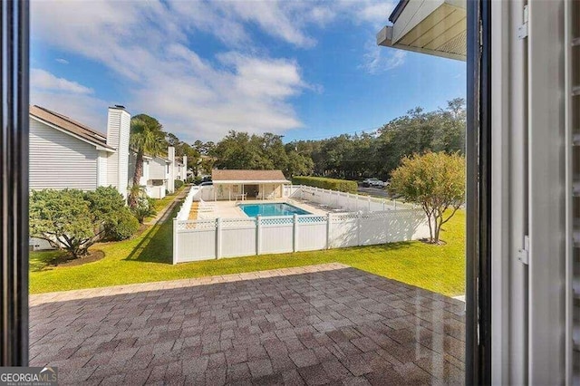 view of swimming pool with a patio and a lawn