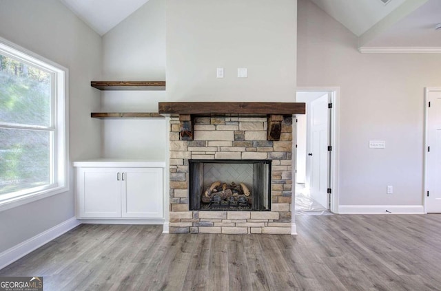 unfurnished living room featuring a fireplace, light wood-type flooring, and a wealth of natural light