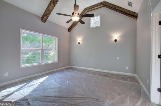 spare room with a healthy amount of sunlight, vaulted ceiling with beams, and light colored carpet