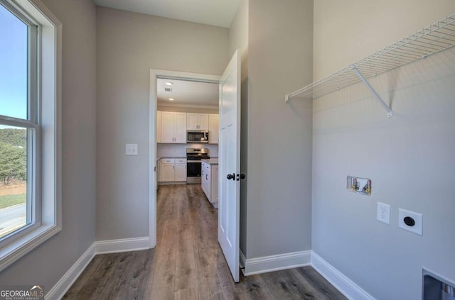 washroom featuring hookup for an electric dryer, dark hardwood / wood-style floors, and hookup for a washing machine