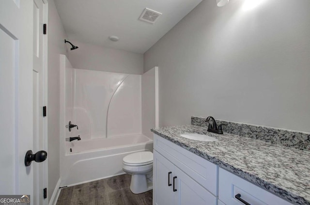 full bathroom featuring bathtub / shower combination, vanity, hardwood / wood-style floors, and toilet