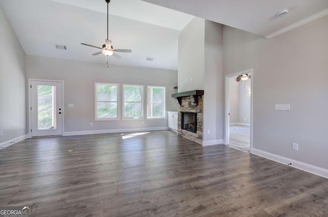 unfurnished living room featuring lofted ceiling, dark wood-type flooring, a fireplace, and ceiling fan