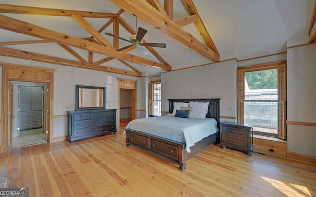 bedroom with light hardwood / wood-style flooring, beamed ceiling, and high vaulted ceiling