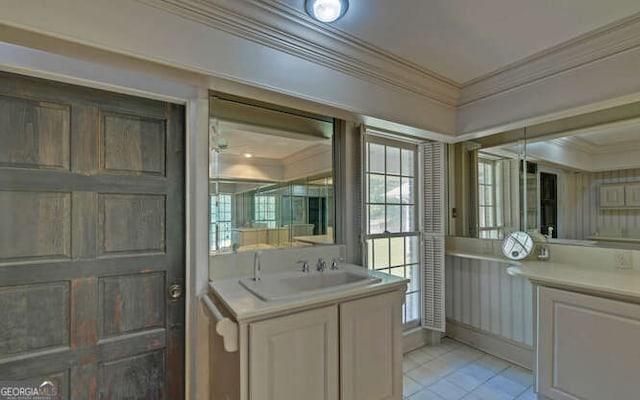 entryway with sink, crown molding, and light tile patterned floors