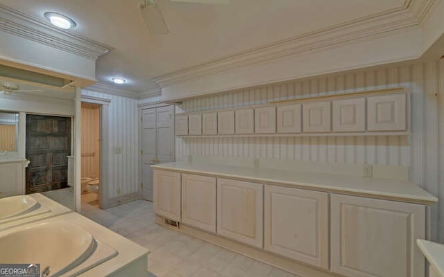 bathroom with crown molding, toilet, and ceiling fan