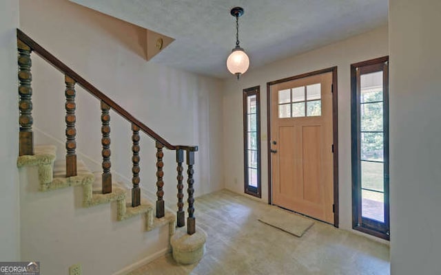 entryway with a textured ceiling