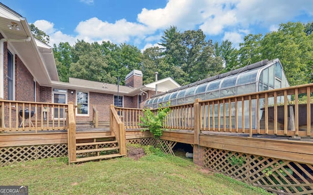 wooden deck featuring a yard