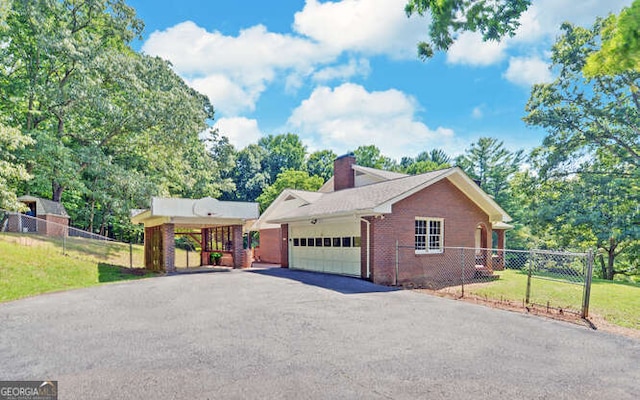 view of front facade with a carport, a front lawn, and a garage