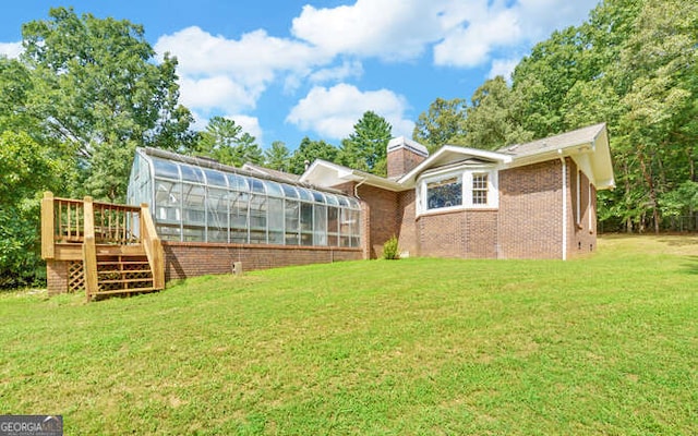 rear view of property featuring a yard