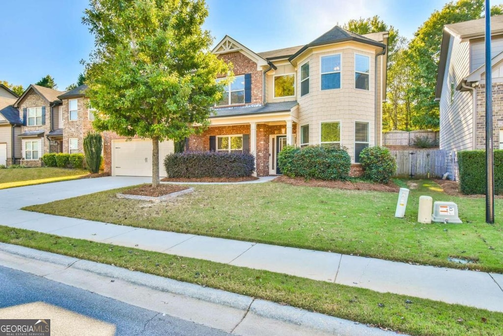 view of front of property with a garage and a front yard