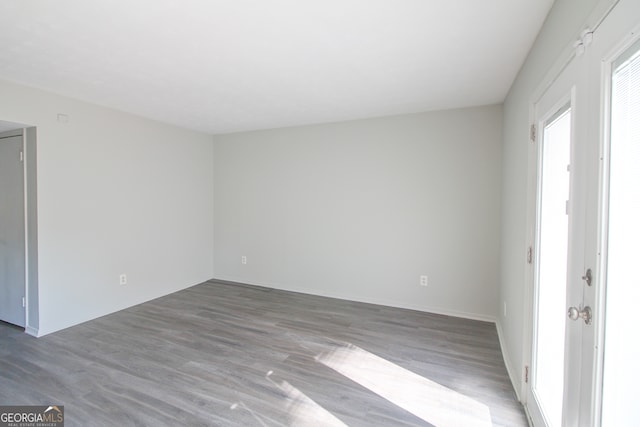 unfurnished room featuring hardwood / wood-style flooring