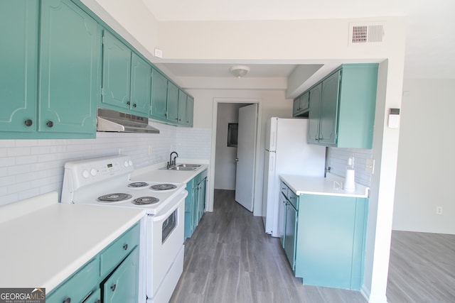 kitchen featuring white appliances, tasteful backsplash, sink, green cabinetry, and light hardwood / wood-style flooring