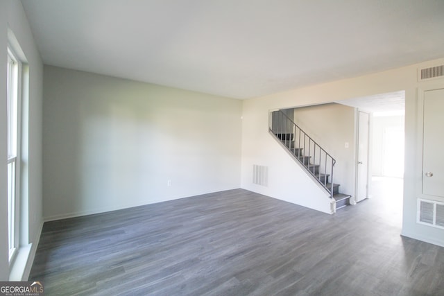 unfurnished room with dark hardwood / wood-style floors