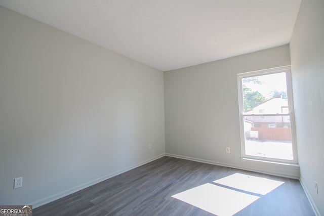 empty room featuring dark wood-type flooring