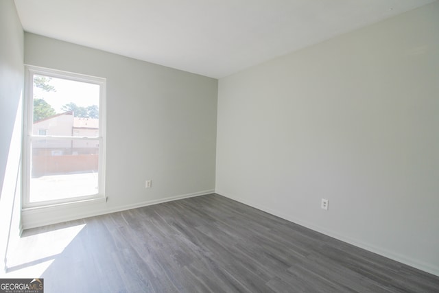 spare room featuring dark hardwood / wood-style flooring