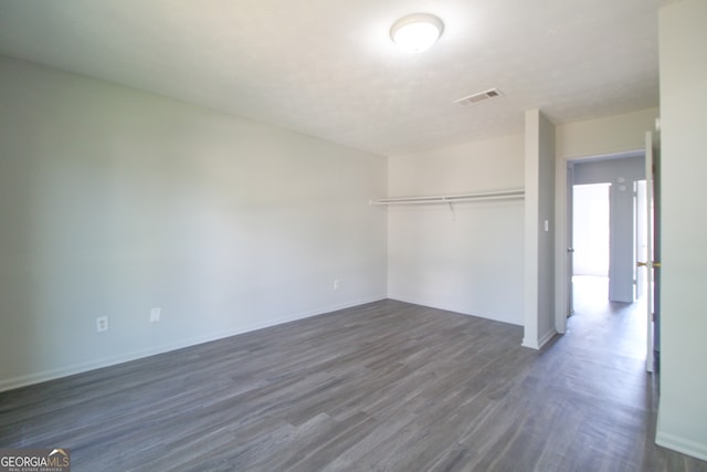 empty room with dark wood-type flooring