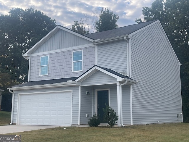 view of front of home featuring a front lawn and a garage