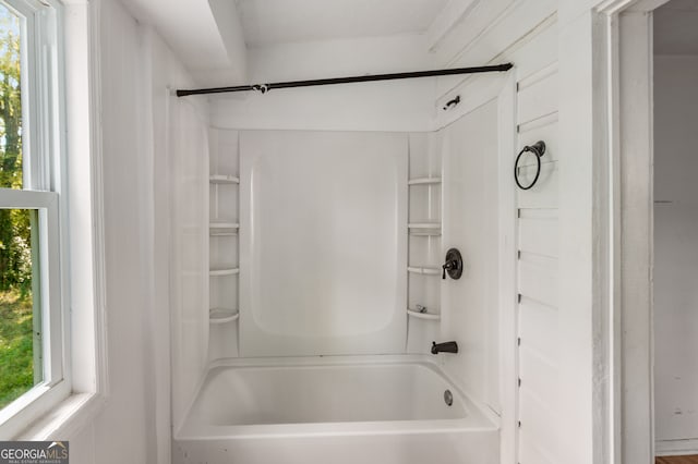 bathroom with a wealth of natural light and bathtub / shower combination