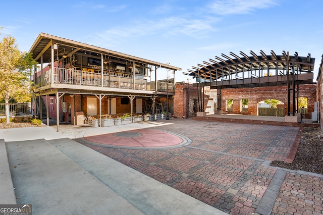 back of house with a pergola and a patio area