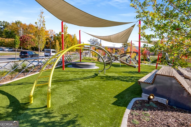 view of playground with a lawn