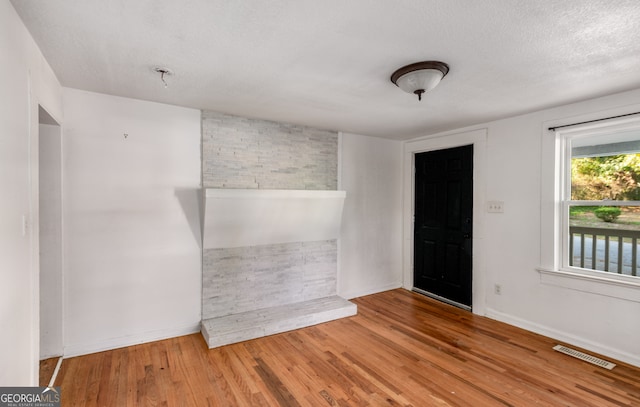 empty room featuring a textured ceiling and hardwood / wood-style flooring