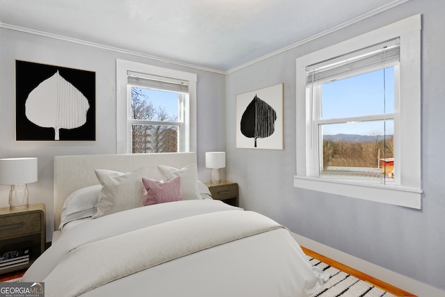 bedroom featuring ornamental molding and wood-type flooring