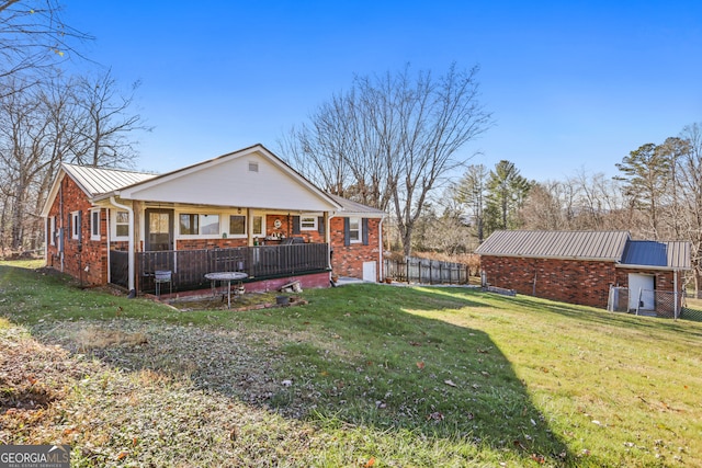 rear view of property with a lawn