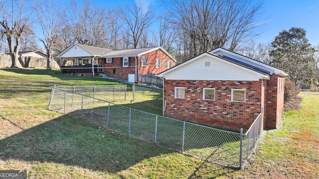 view of side of home with a yard