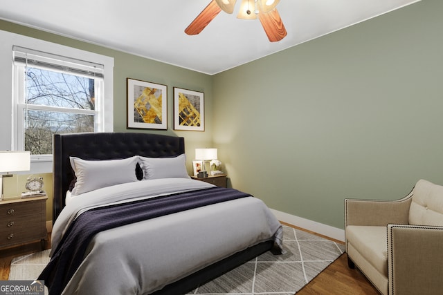 bedroom featuring hardwood / wood-style flooring and ceiling fan