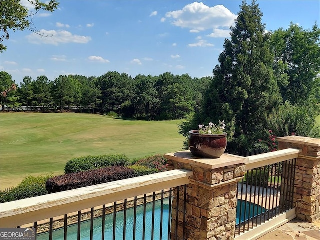 view of community featuring a pool and a yard