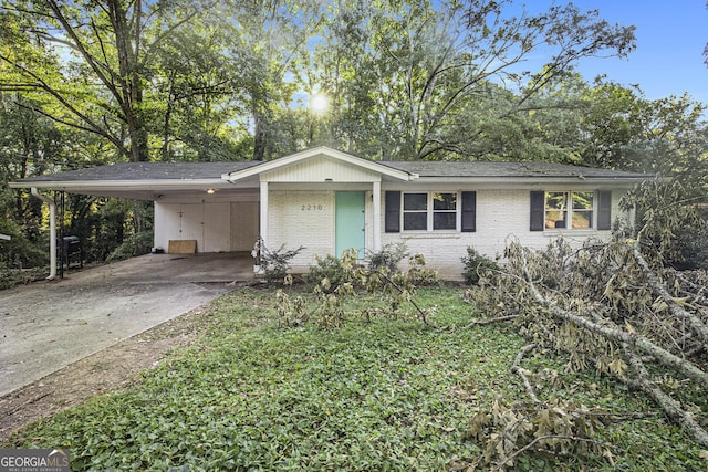 2210 Rhinehill Rd SE, Atlanta, GA 30315 - ranch-style home with roof with shingles, concrete driveway, an attached carport, and brick siding