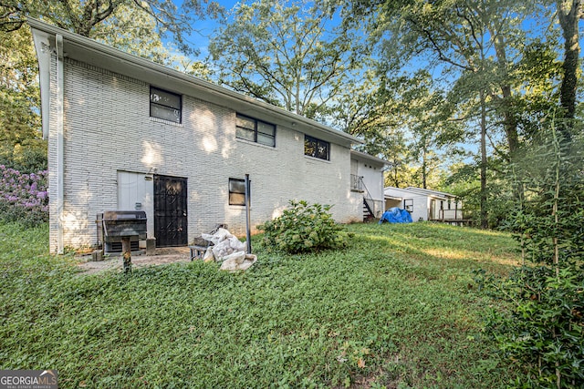 back of house with a lawn