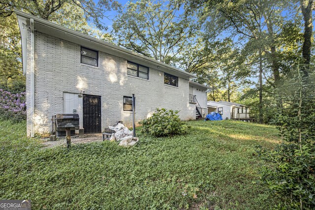 2210 Rhinehill Rd SE, Atlanta, GA 30315 - rear view of property with a yard and brick siding