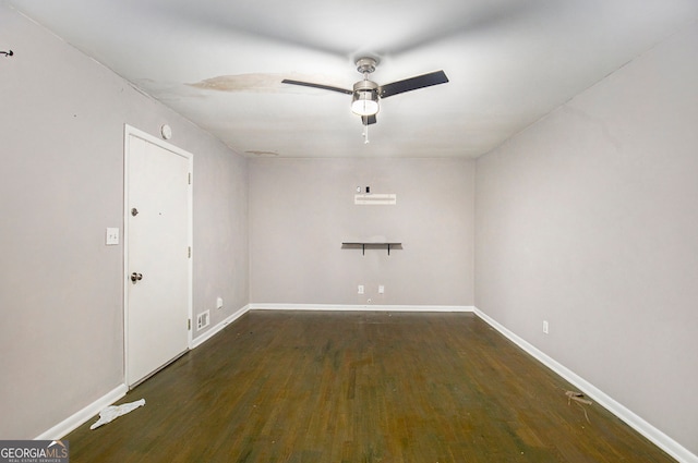 spare room with ceiling fan and dark hardwood / wood-style flooring