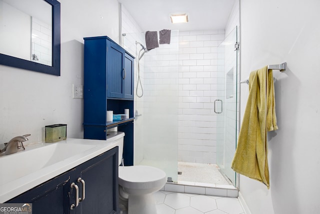 bathroom featuring vanity, tile patterned floors, toilet, and walk in shower